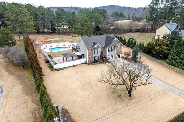 view of front of house with a garage and a shed