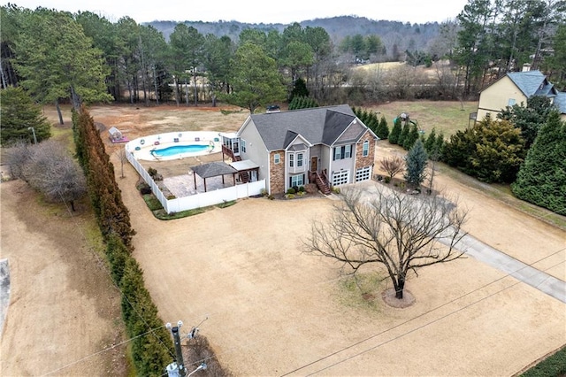 aerial view featuring a wooded view