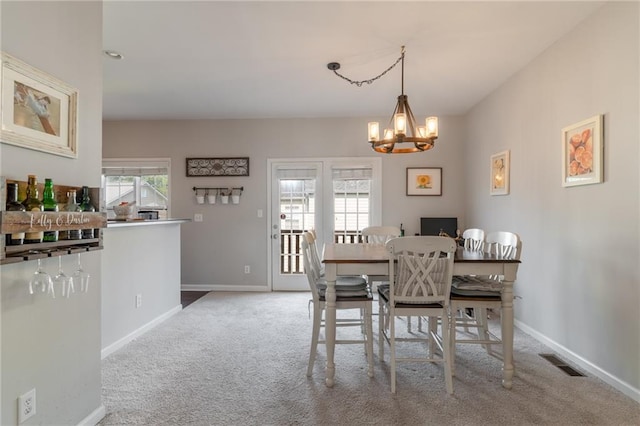 6004 Turfway Park Ct, Sugar Hill, GA 30518 - carpeted dining room featuring a chandelier and baseboards