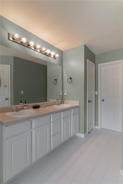 6004 Turfway Park Ct, Sugar Hill, GA 30518 - full bathroom featuring double vanity, tile patterned floors, and baseboards