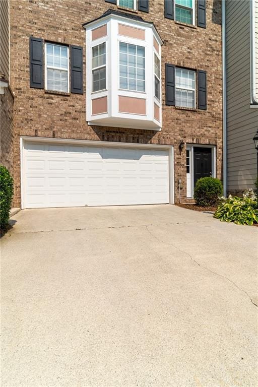 6004 Turfway Park Ct, Sugar Hill, GA 30518 - view of front of house with brick siding, driveway, and an attached garage