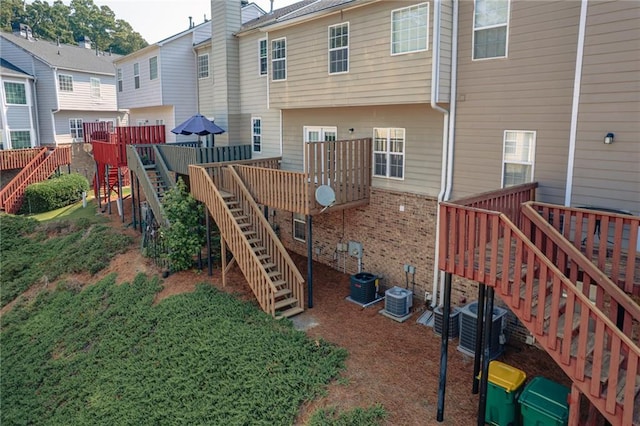 6004 Turfway Park Ct, Sugar Hill, GA 30518 - rear view of house with stairway, central AC, and a deck