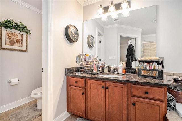 bathroom with vanity, toilet, and crown molding