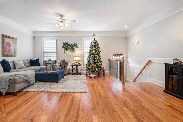 living room featuring ceiling fan, light hardwood / wood-style floors, and ornamental molding