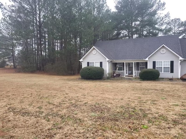 view of front of home with a front yard and covered porch