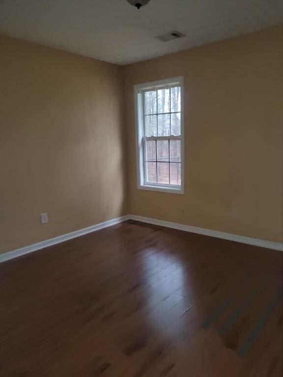 unfurnished room with dark hardwood / wood-style floors