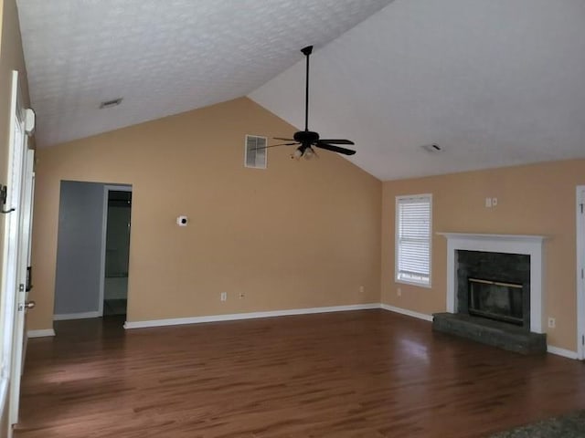 unfurnished living room with dark wood-type flooring, a premium fireplace, ceiling fan, high vaulted ceiling, and a textured ceiling