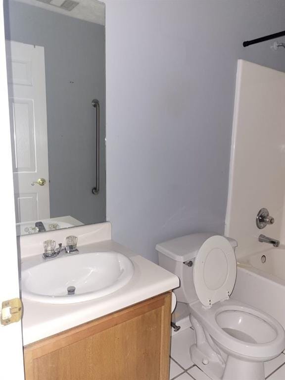 full bathroom featuring vanity, bathtub / shower combination, and toilet