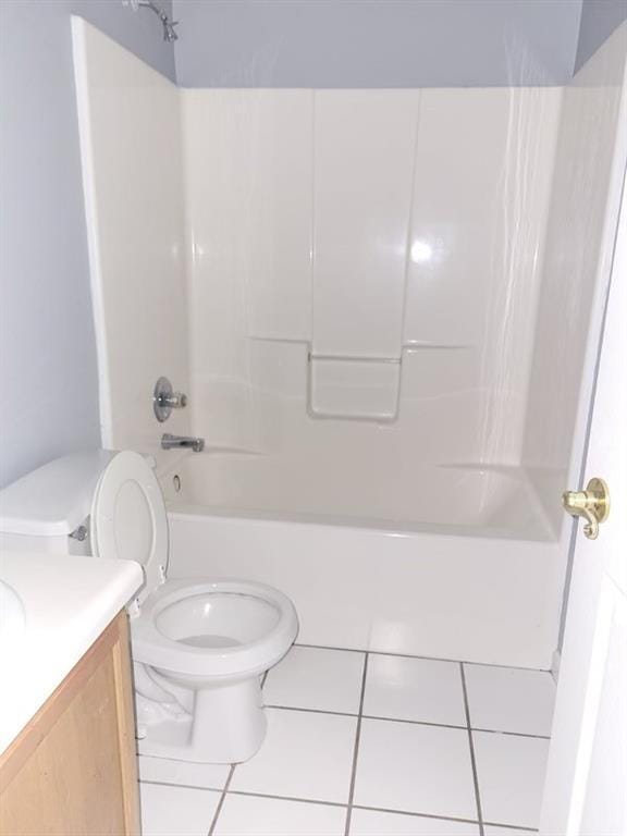 full bathroom with shower / tub combination, tile patterned floors, toilet, and vanity