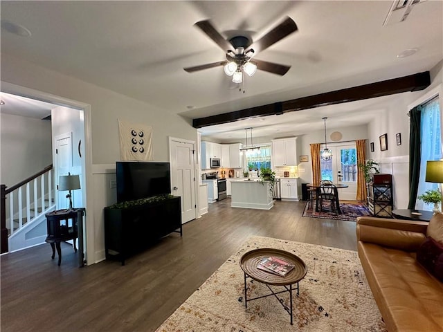 living room featuring beam ceiling, dark hardwood / wood-style flooring, french doors, and ceiling fan with notable chandelier