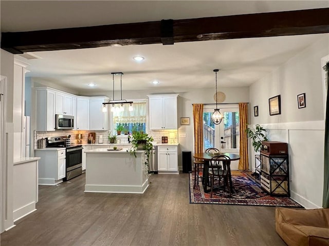 kitchen featuring pendant lighting, white cabinets, and stainless steel appliances