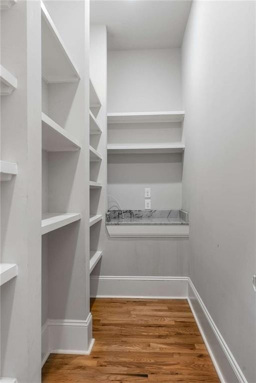 spacious closet featuring hardwood / wood-style floors