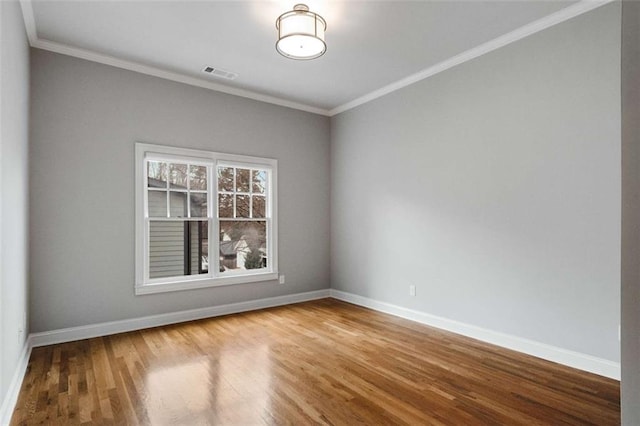 spare room with wood-type flooring and ornamental molding