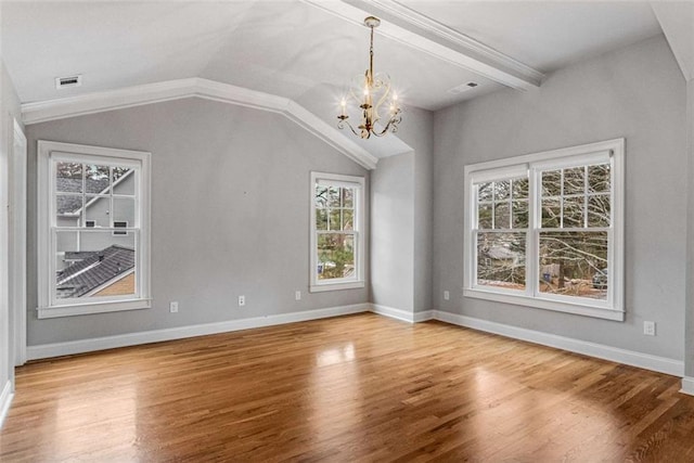 interior space with hardwood / wood-style floors, a wealth of natural light, lofted ceiling with beams, and a chandelier