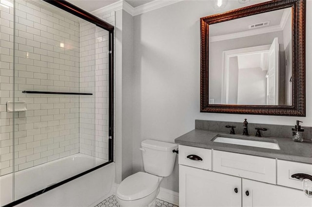 full bathroom featuring crown molding, combined bath / shower with glass door, tile patterned flooring, vanity, and toilet