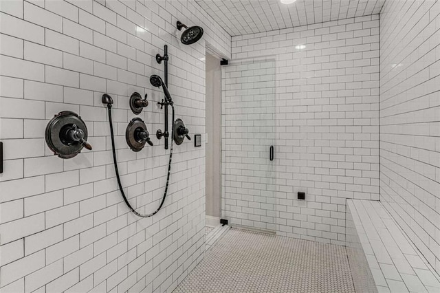 bathroom featuring a tile shower and tile patterned floors