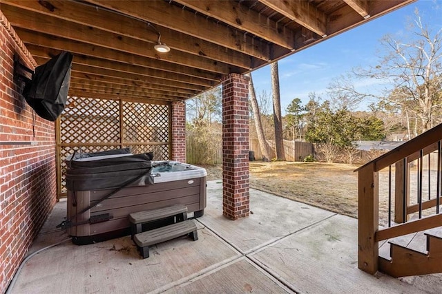 view of patio / terrace with a hot tub and area for grilling