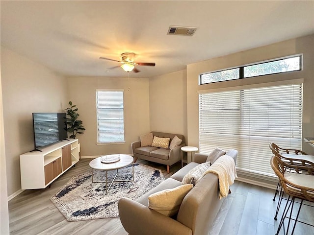 living room featuring light hardwood / wood-style floors and ceiling fan