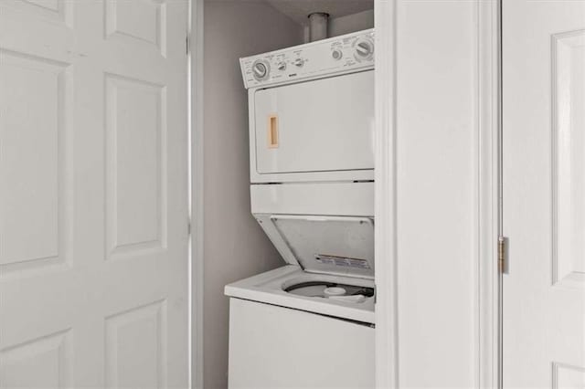 clothes washing area featuring stacked washer / drying machine