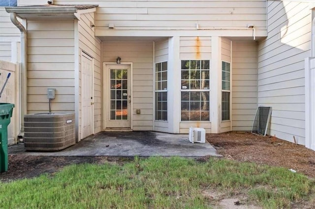 entrance to property with cooling unit and a patio