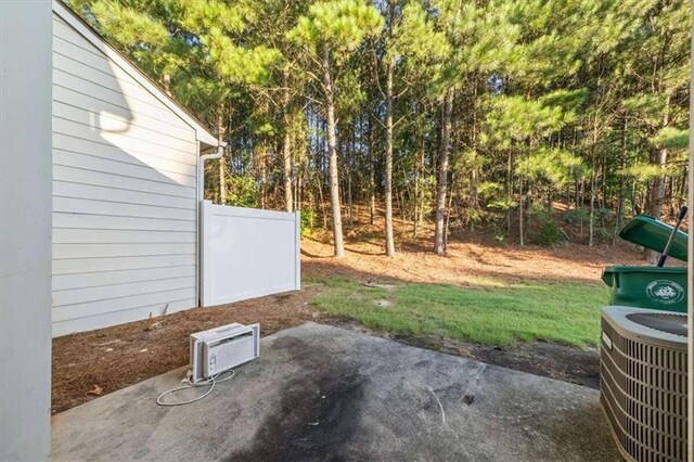 view of yard with central AC unit and a patio