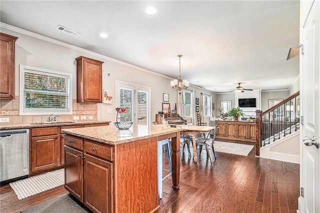 kitchen featuring dark hardwood / wood-style floors, tasteful backsplash, stainless steel dishwasher, and a kitchen island