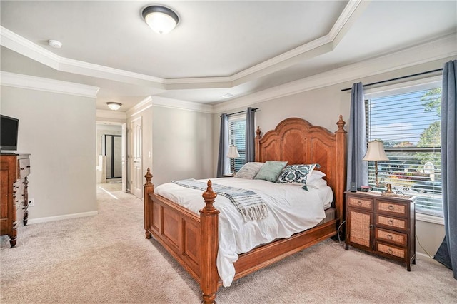 carpeted bedroom with crown molding and a tray ceiling