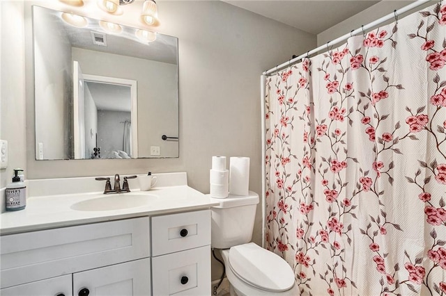 bathroom with vanity, toilet, and curtained shower