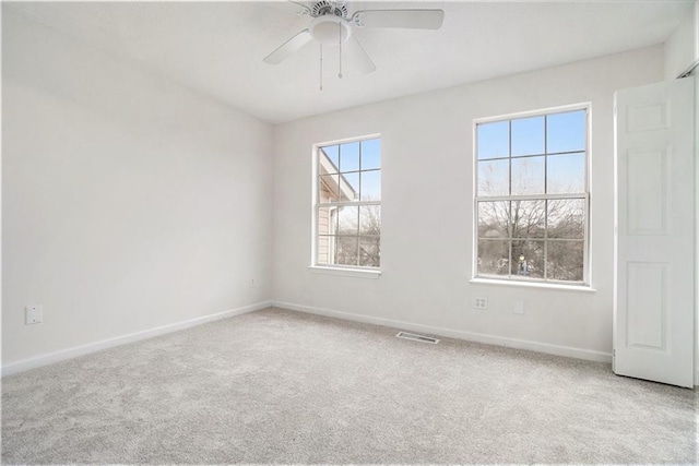 unfurnished room with light carpet and ceiling fan