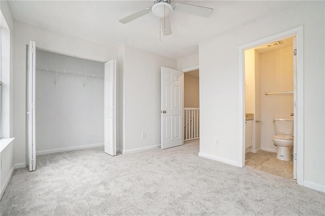 unfurnished bedroom with ensuite bathroom, light carpet, ceiling fan, and a closet