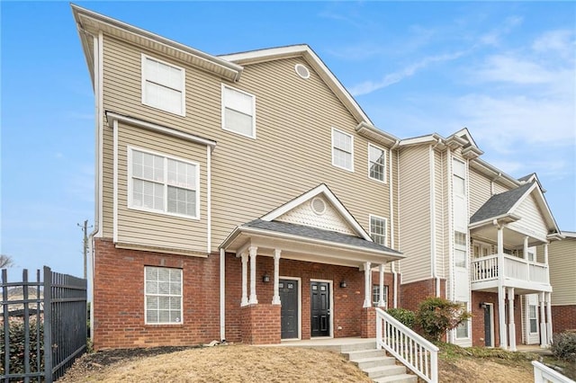 townhome / multi-family property featuring covered porch