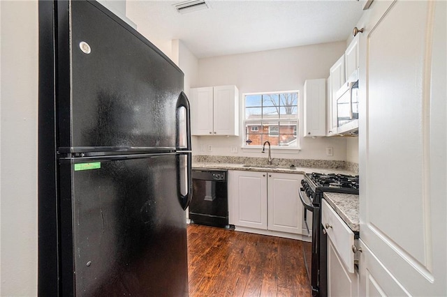 kitchen with white cabinetry, sink, dark wood-type flooring, and black appliances