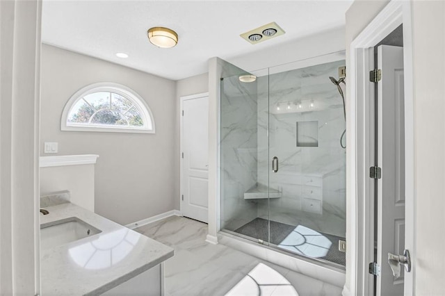 bathroom with vanity and a shower with shower door