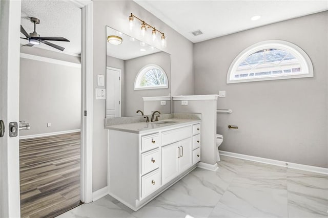 bathroom featuring vanity, ceiling fan, and toilet