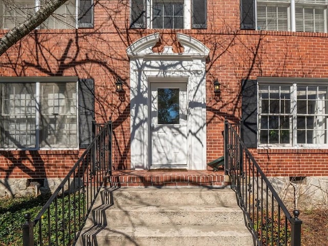 doorway to property with brick siding and crawl space