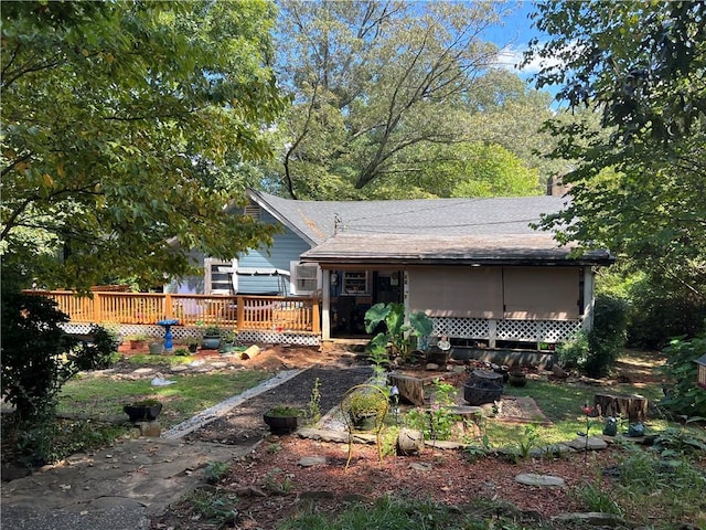 back of property with a wooden deck