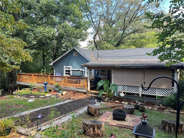 back of house with a wooden deck