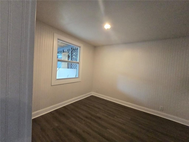 spare room with dark wood-type flooring