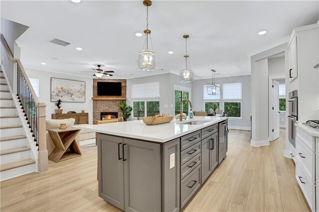 kitchen featuring a spacious island, white cabinetry, stainless steel appliances, and pendant lighting