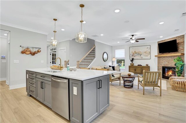 kitchen with a breakfast bar, pendant lighting, an island with sink, white cabinetry, and stainless steel appliances