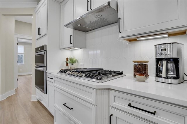 kitchen featuring sink, gray cabinetry, hanging light fixtures, stainless steel appliances, and white cabinets