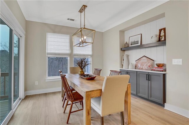 kitchen featuring white cabinetry, tasteful backsplash, light hardwood / wood-style floors, and appliances with stainless steel finishes