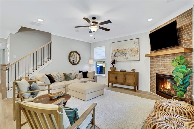 dining space with sink, ceiling fan with notable chandelier, and light hardwood / wood-style floors