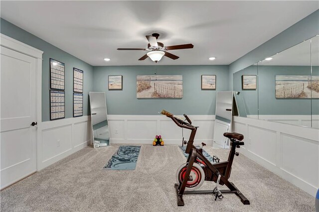 living room with ceiling fan, ornamental molding, light wood-type flooring, and a fireplace