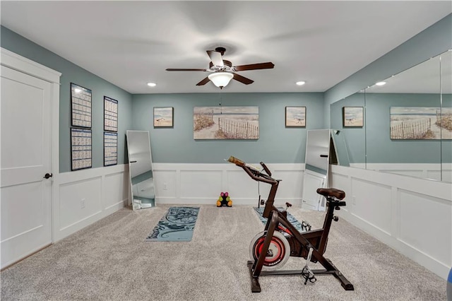 workout area featuring light colored carpet and ceiling fan