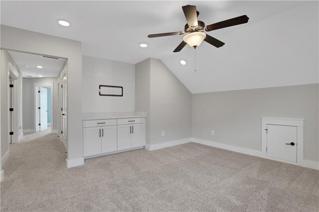 bedroom featuring light wood-type flooring, ceiling fan, and a tray ceiling