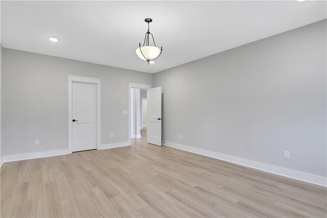 kitchen featuring white cabinetry, sink, wine cooler, backsplash, and light wood-type flooring