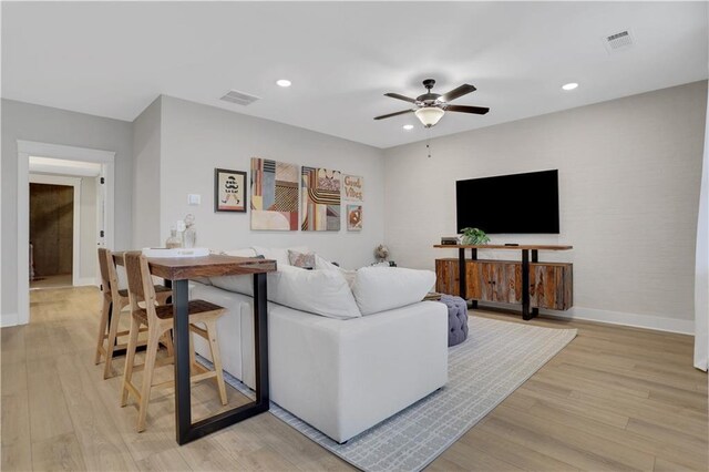 bar with white cabinetry, beverage cooler, sink, and light hardwood / wood-style flooring