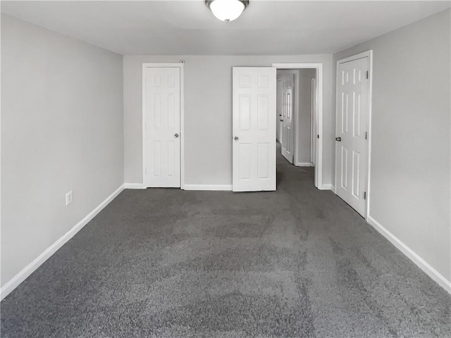 unfurnished bedroom with dark colored carpet