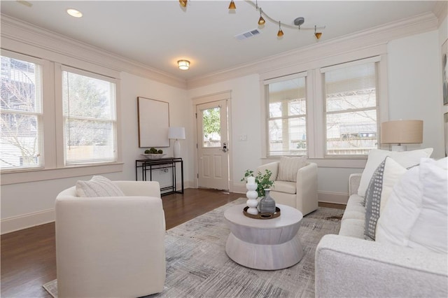 living area with crown molding, wood finished floors, visible vents, and baseboards